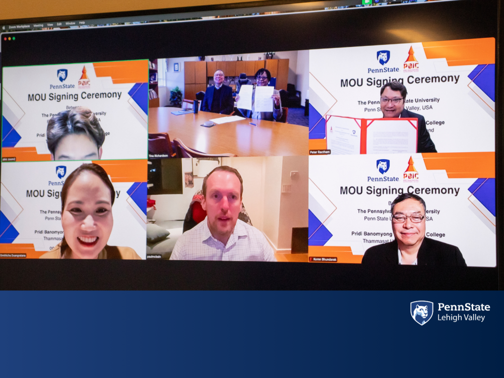 a zoom screen of 7 individuals smiling 