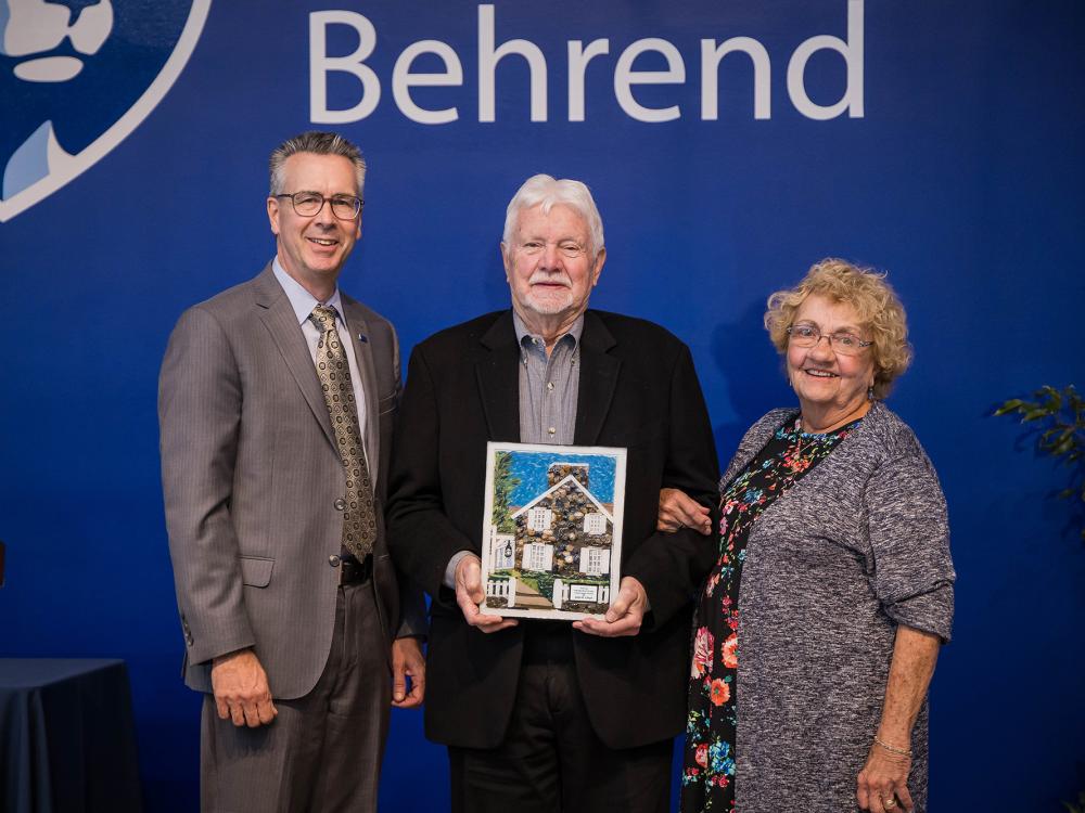Penn State Behrend Chancellor Ralph Ford presents the Behrend Distinguished Alumni Award to John B. Lloyd and Jean Chambers Lloyd.