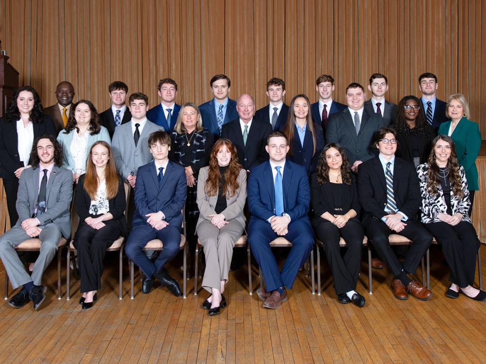 A group of students, faculty, staff and donors posing for a photo at the induction of the 14th class of Sheetz Fellows