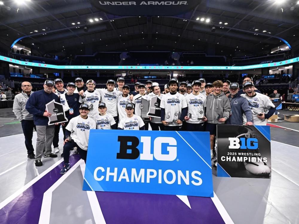 Team poses with championship banner