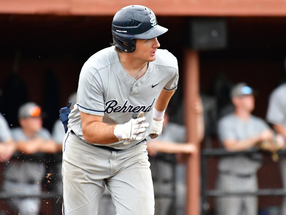 A Penn State Behrend baseball player runs to first base.