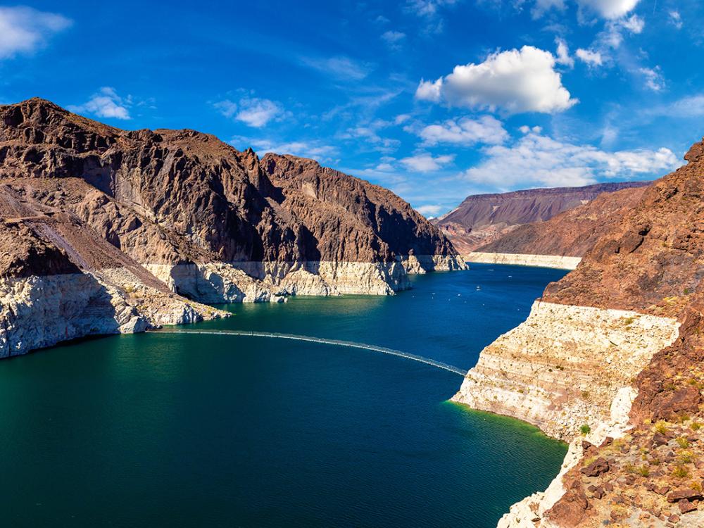 Lake Mead under blue skies showing decreased depth due to less water