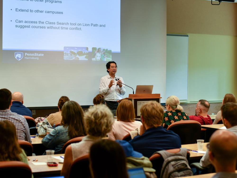 Speaker presenting in front of seated audience