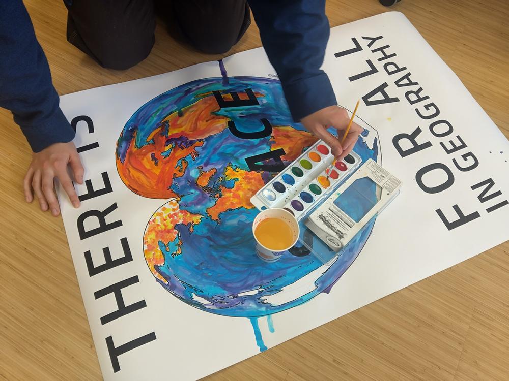 student painting a map for the geographics lab