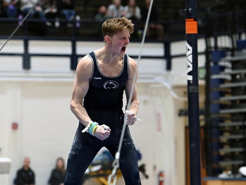 Gymnast celebrates after high-bar routine