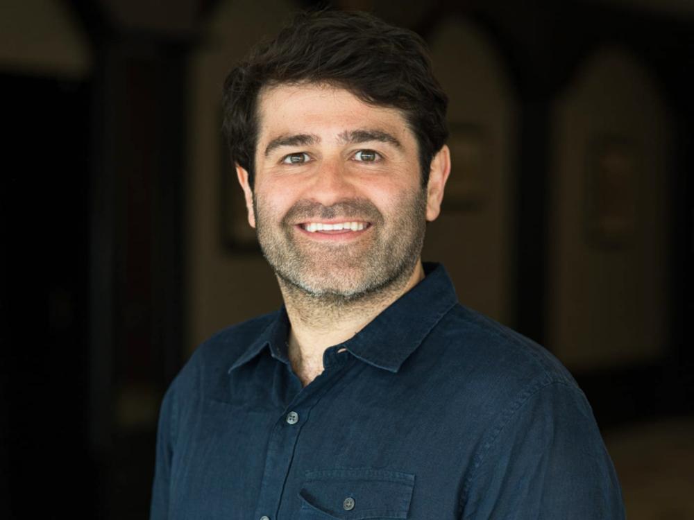 A head and shoulders photo of a smiling Slava Rubin