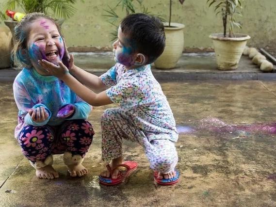 Two toddlers playing together with chalk