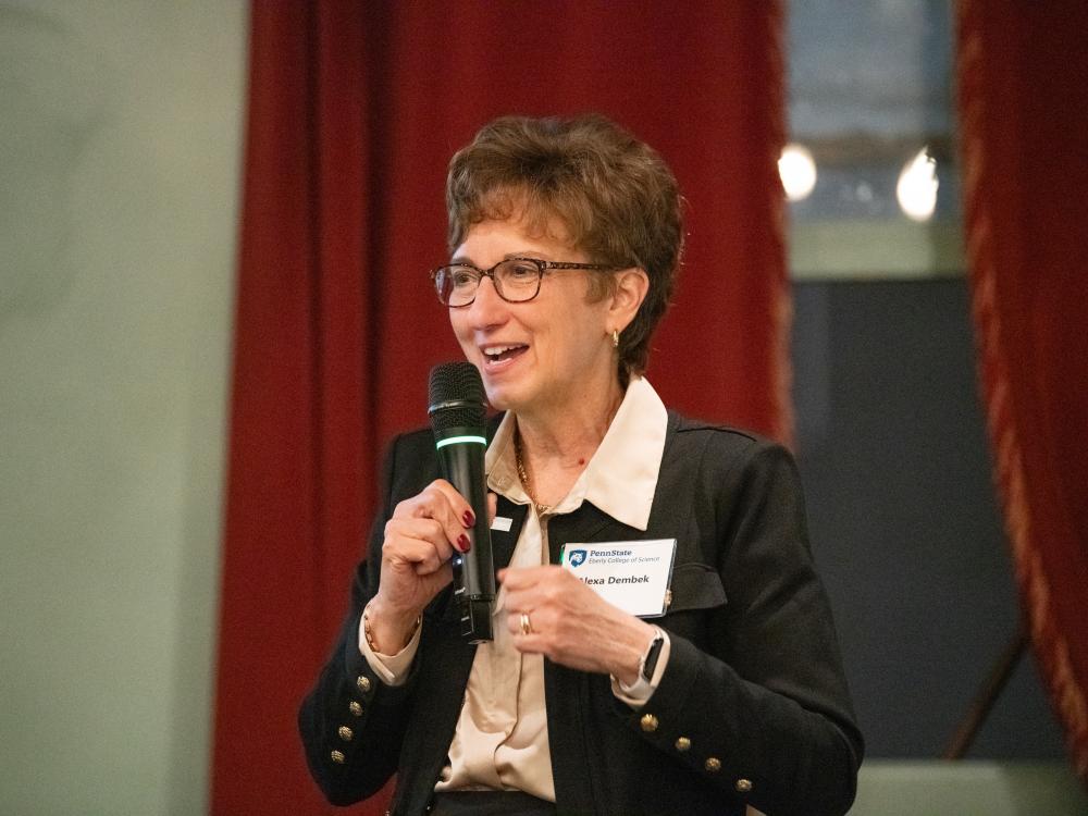 Woman speaking while holding a microphone