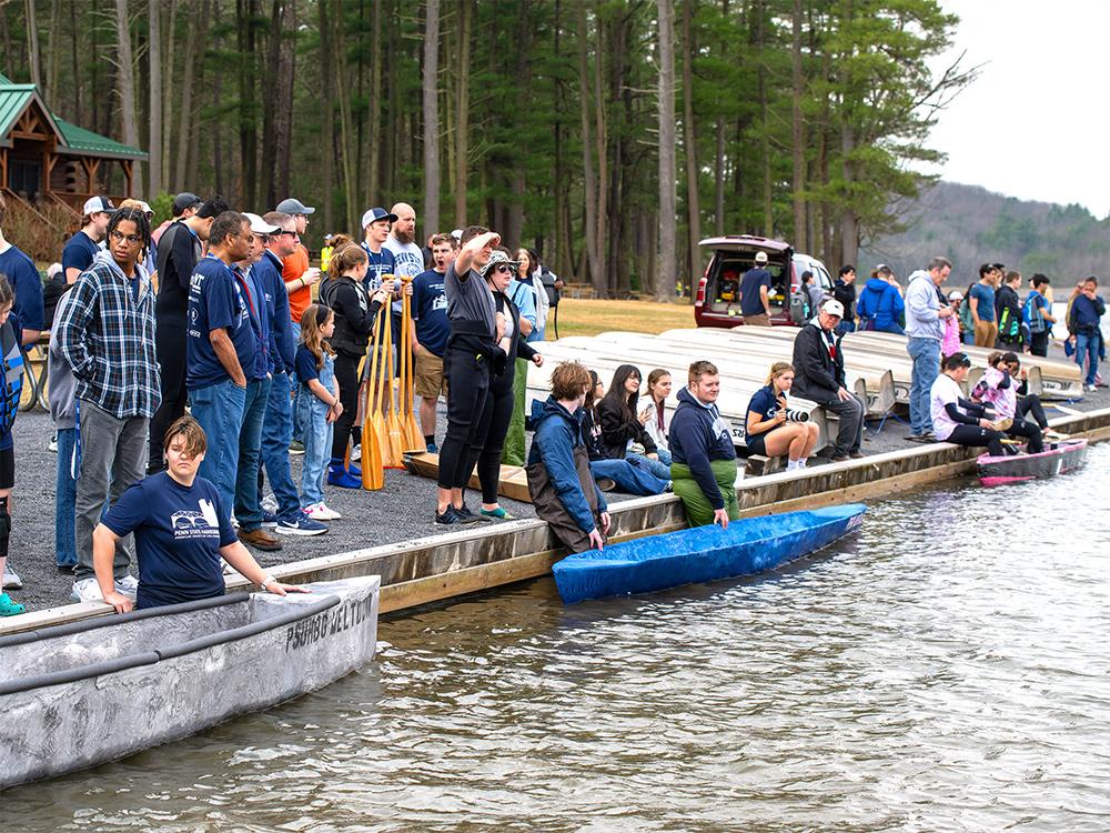A large group of students, faculty and sponsors observe the 2025 concrete canoe competition