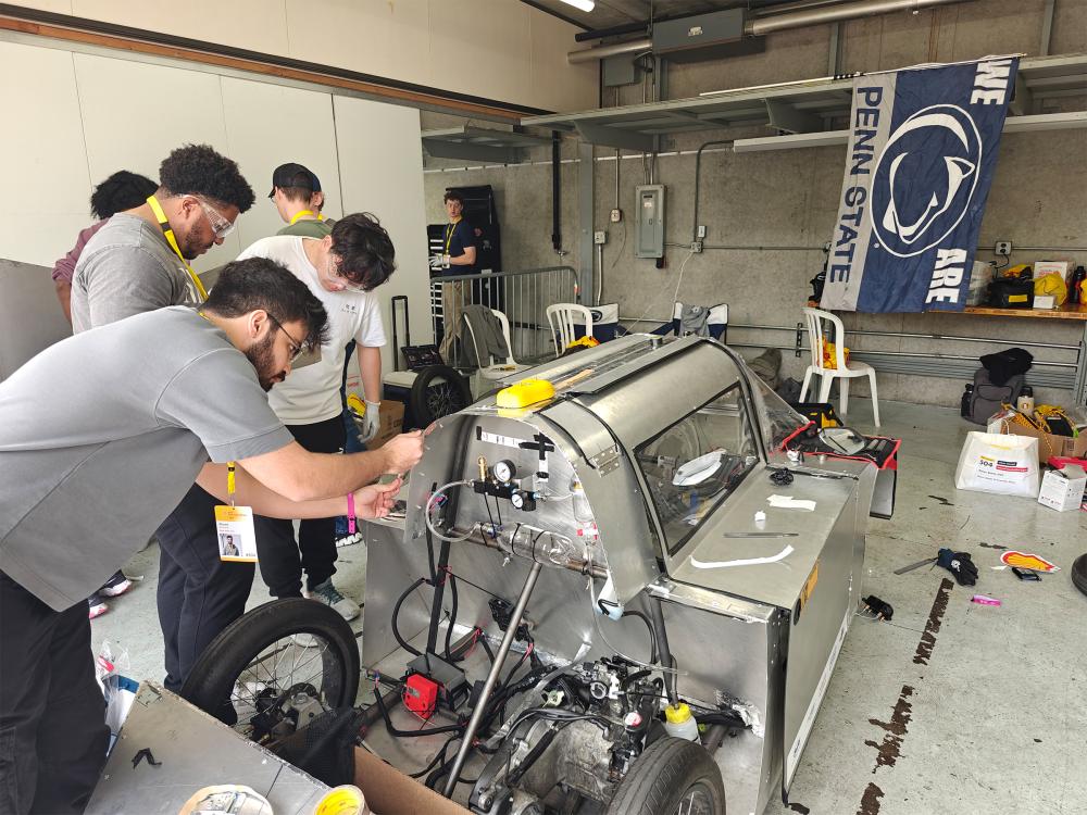Students working on creating a car for a competition.