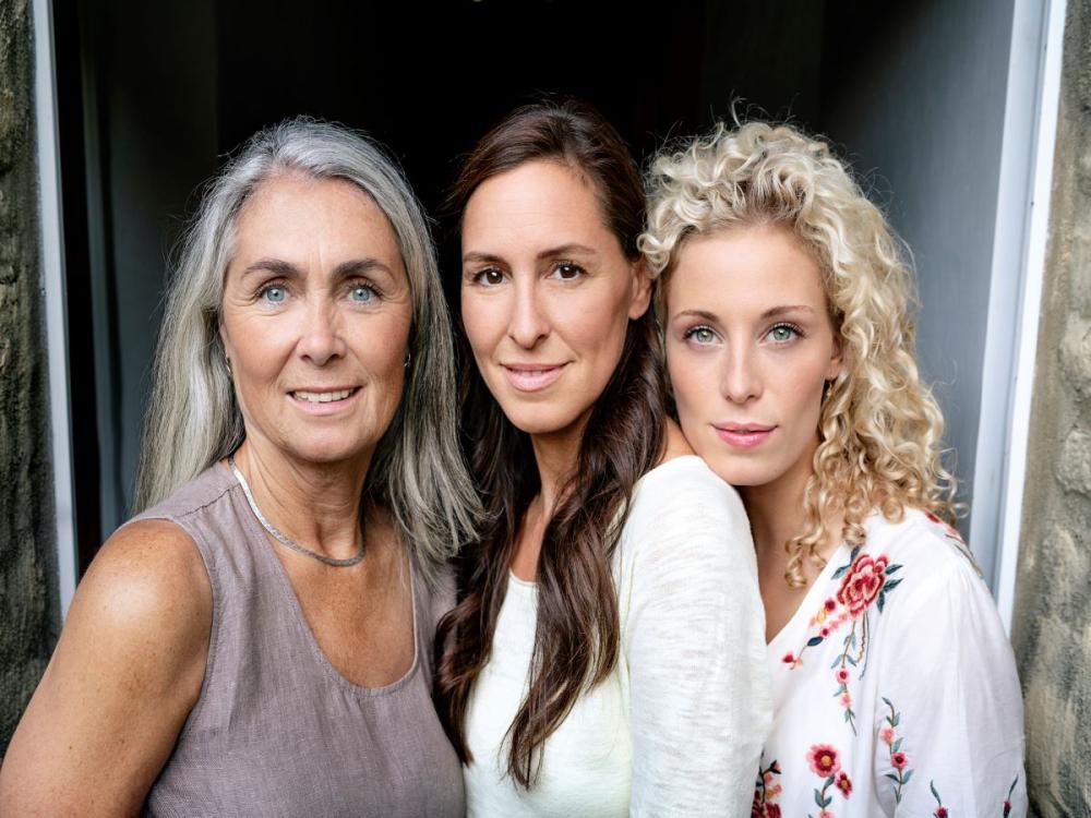 Portrait of three smiling women of different ages