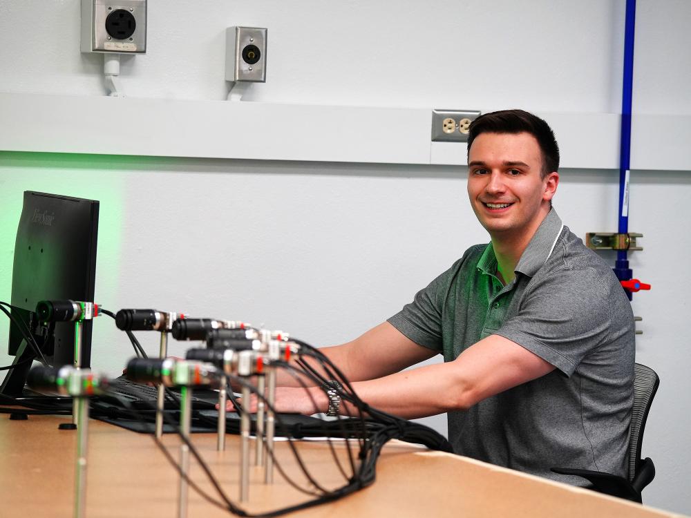 man sitting at computer posing for photo