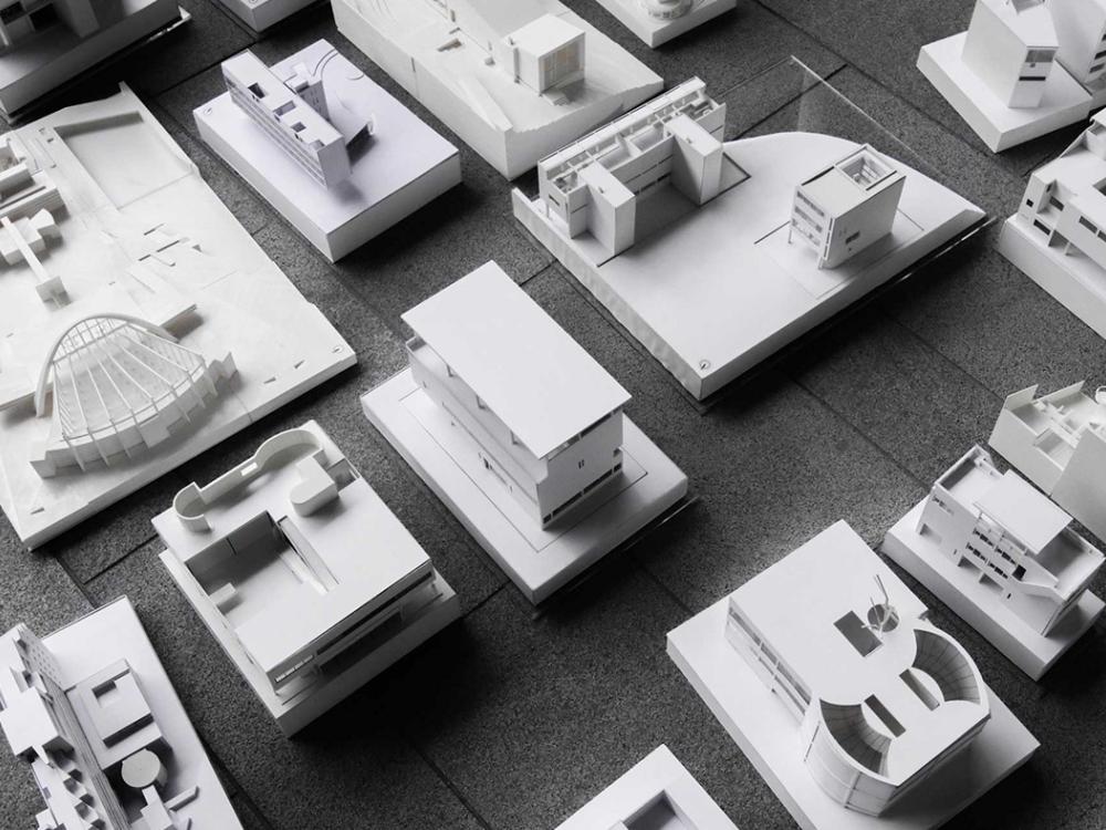 A black and white photograph of several architectural models. 