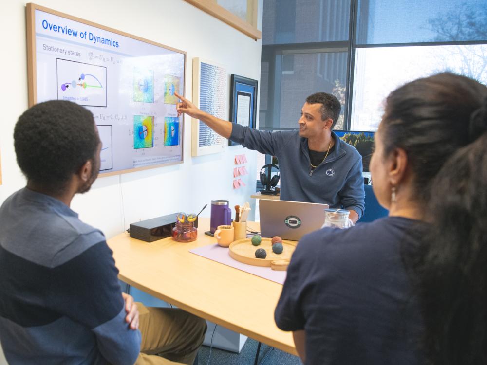 A team of researchers looking at a graphic on a screen