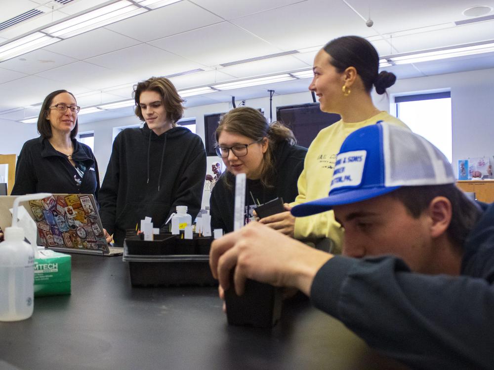 Professor Meg Van Etten and students work with plants in the campus' bio lab 