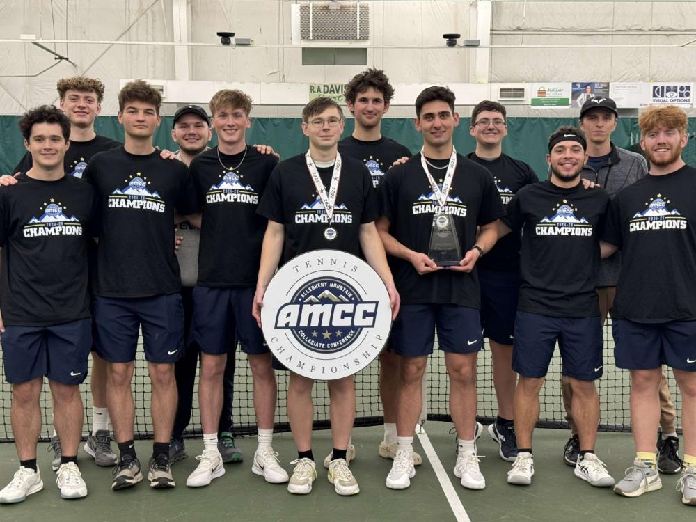 The Penn State Behrend men's tennis team poses with the AMCC championship banner.