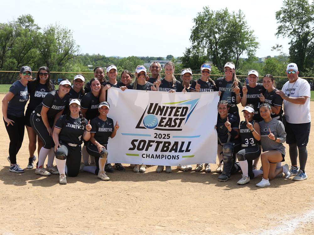 Penn State Brandywine softball team poses with its United East championship banner
