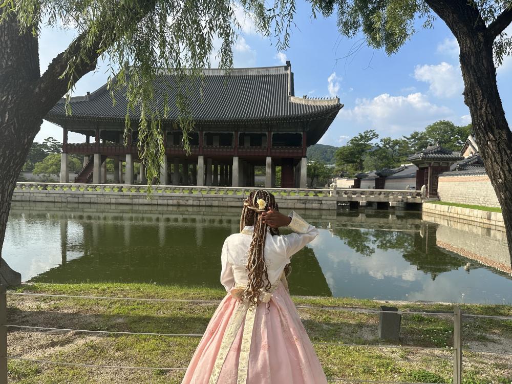 A woman standing in front of a pagoda