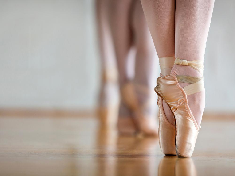 A ballet dancer on pointe in ballet shoes