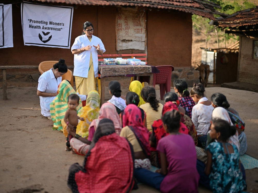 A health worker talks to group of women in Nepal