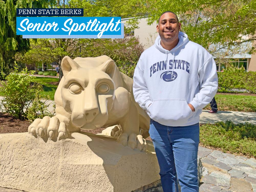 Christian Clarke standing by the lion shrine