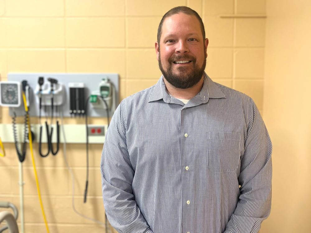 Daniel Eaton, a nursing instructor at Penn State Behrend, poses in a simulation lab.