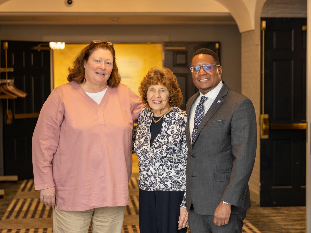 Kathryn Salzer stands with Sue Paterno and Clarence Lang.