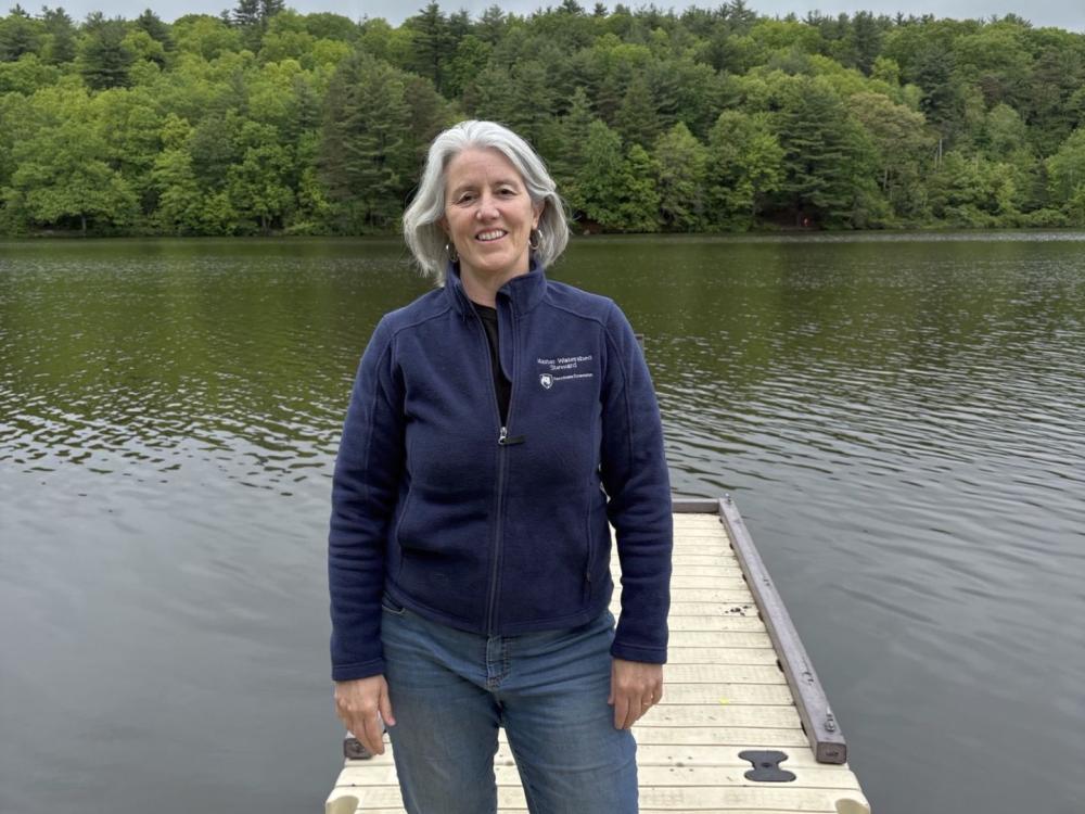 Master Watershed Steward Christine Boyle stands on a dock