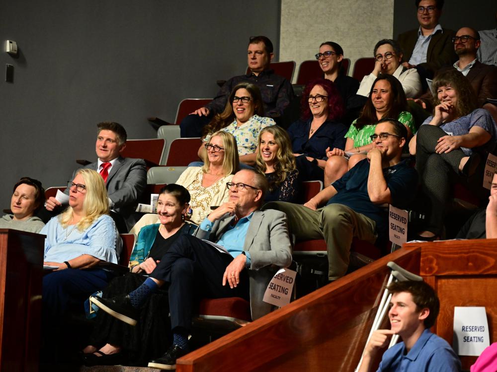 Audience members smile and laugh during the Celebration of Excellence event at Penn State New Kensington, seated in the campus theatre’s reserved section.
