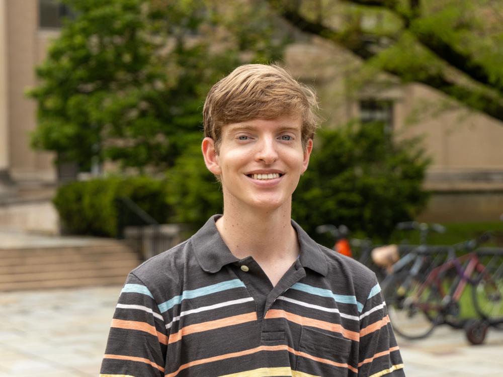 Nathan Noel stands outdoors on Penn State’s campus.