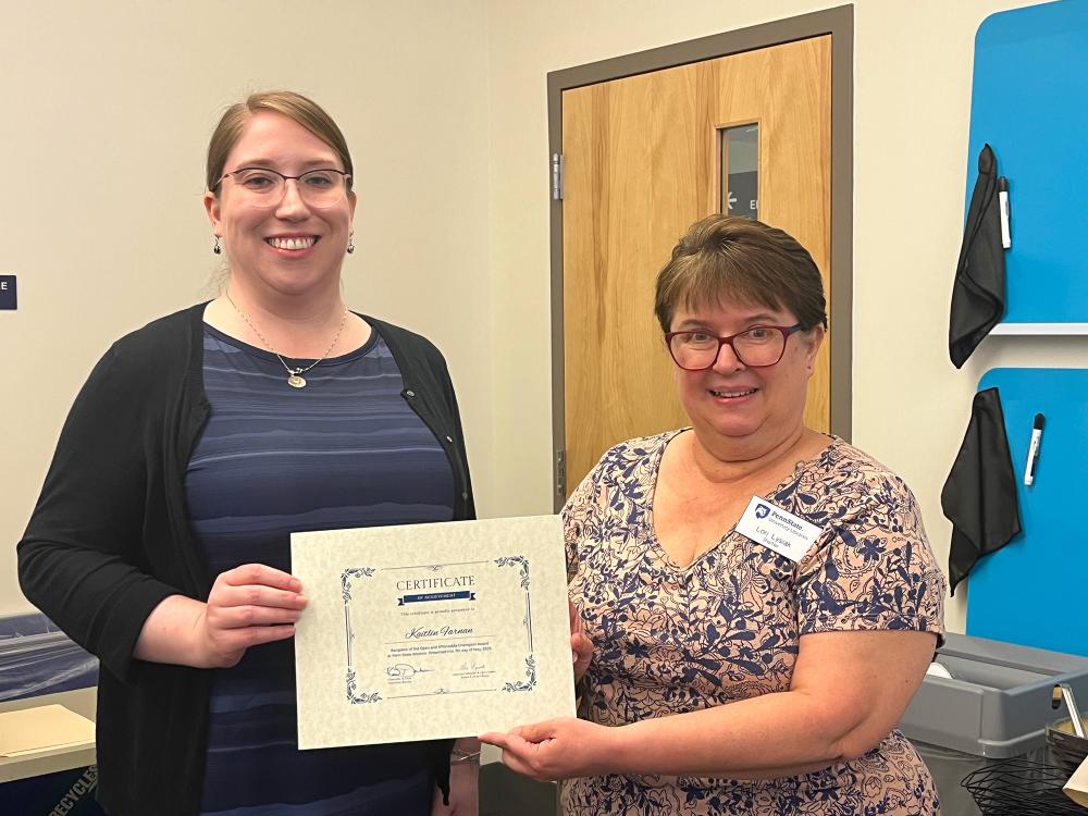 Kaitlin Farnan (L) is presented with an award certificate by Lori Lysiak, reference and instruction librarian at Eiche Library.