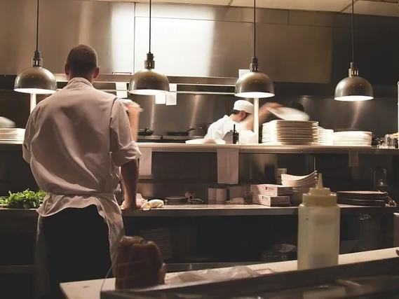 two people working in food prep area