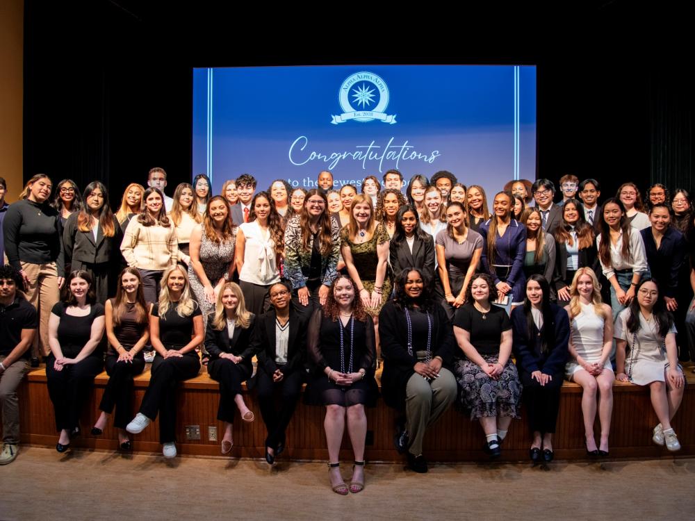 Large group of students posing for a photo on a stage