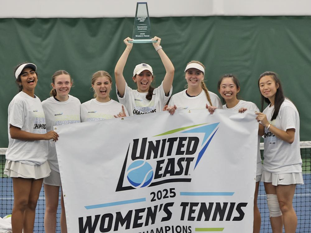 A group of women holding a banner that says United East 2025 women's tennis champions