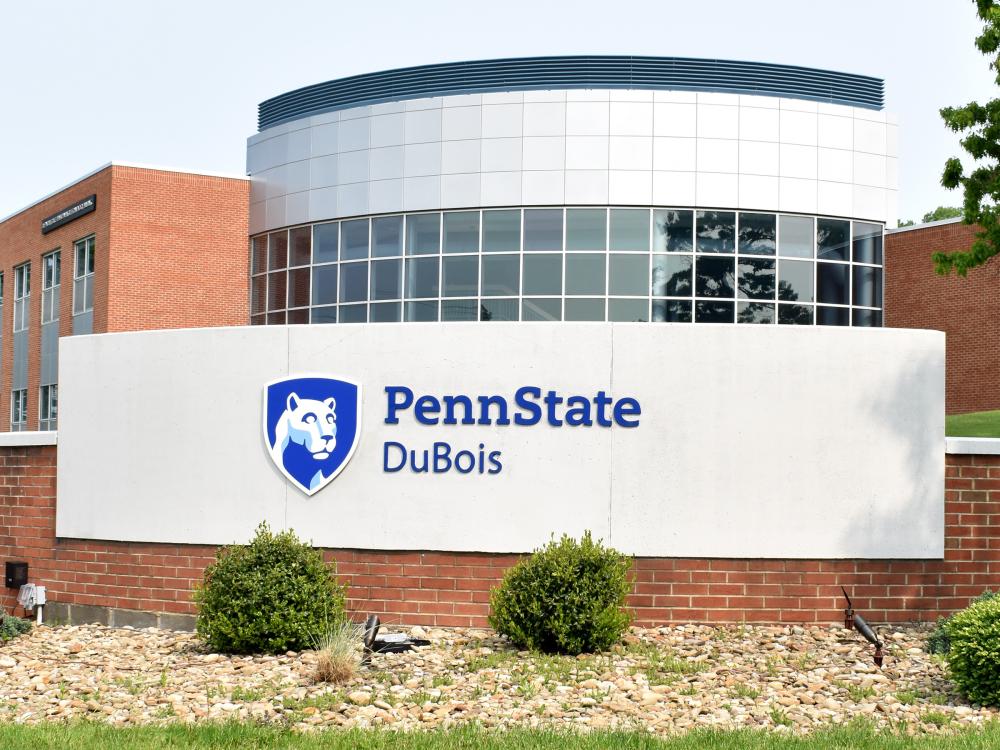 One of the entrance markers at Penn State DuBois. The entrance marker sits in the foreground, with the DEF Building visible in the background.