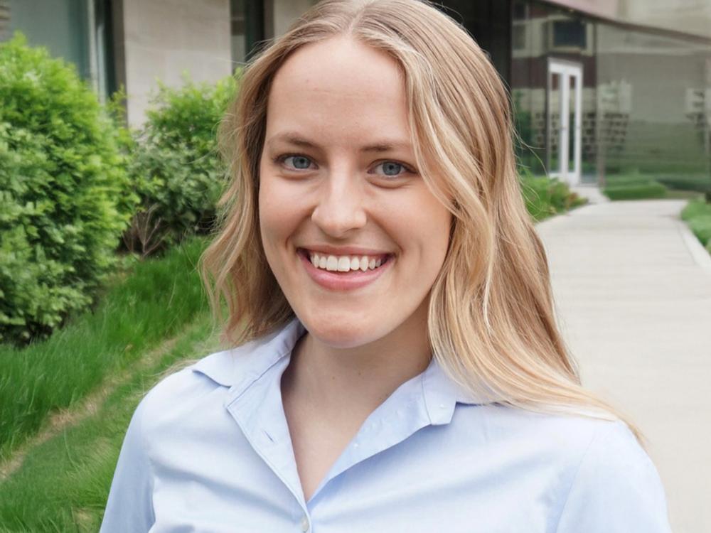 Person standing outside smiling at camera