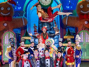 Cirque performer group on a colorful stage