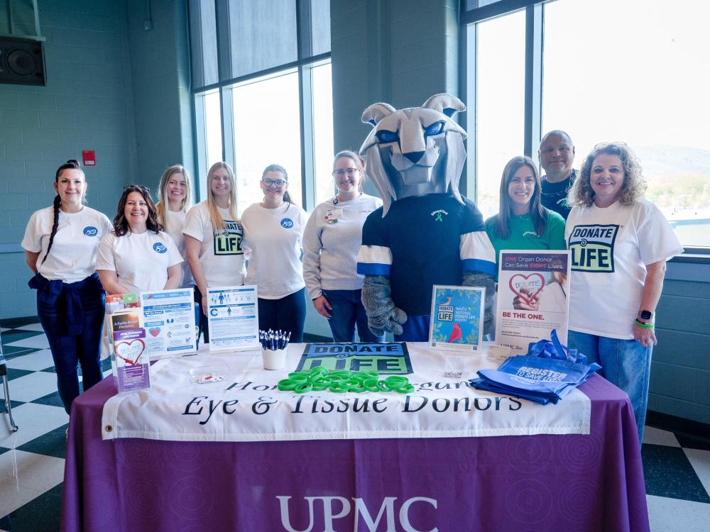 A group of people and the Penn College Wildlife mascot gather at a Donate Life event at Penn College.