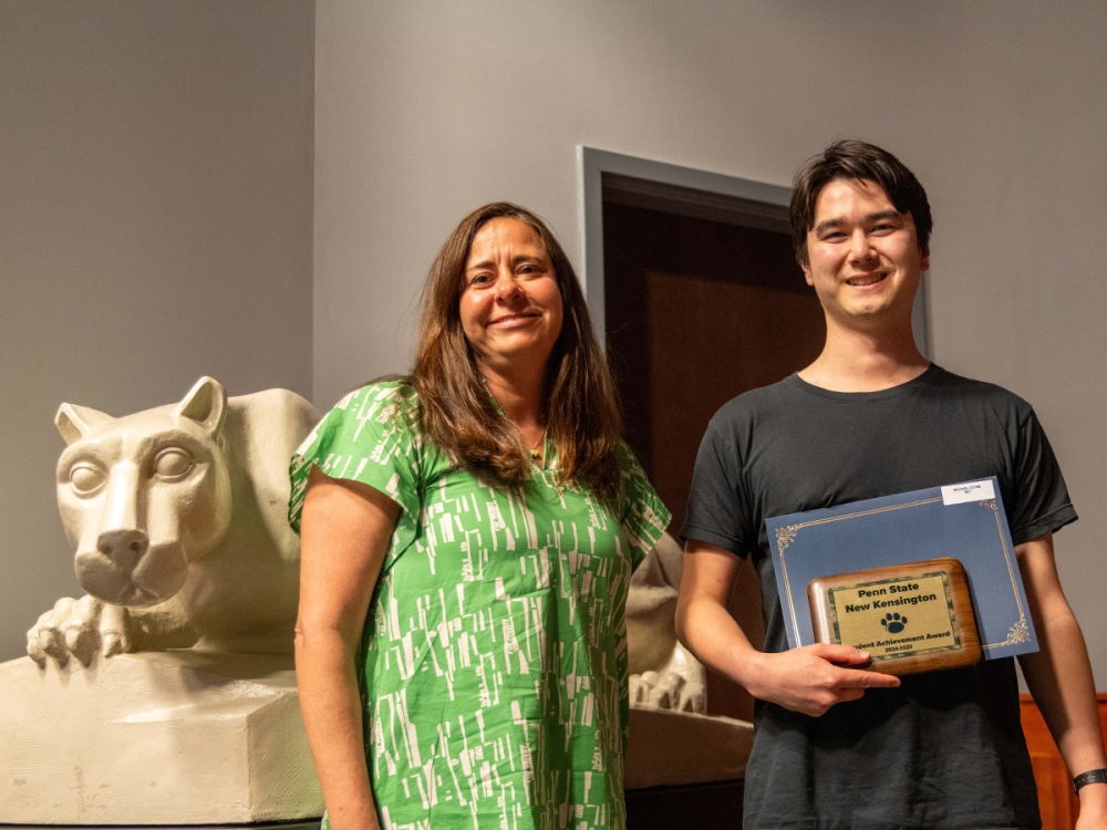 Michael Coyne and Joie Marhefka pose in front of the Nittany Lion statue during Penn State New Kensington’s Celebration of Excellence event.