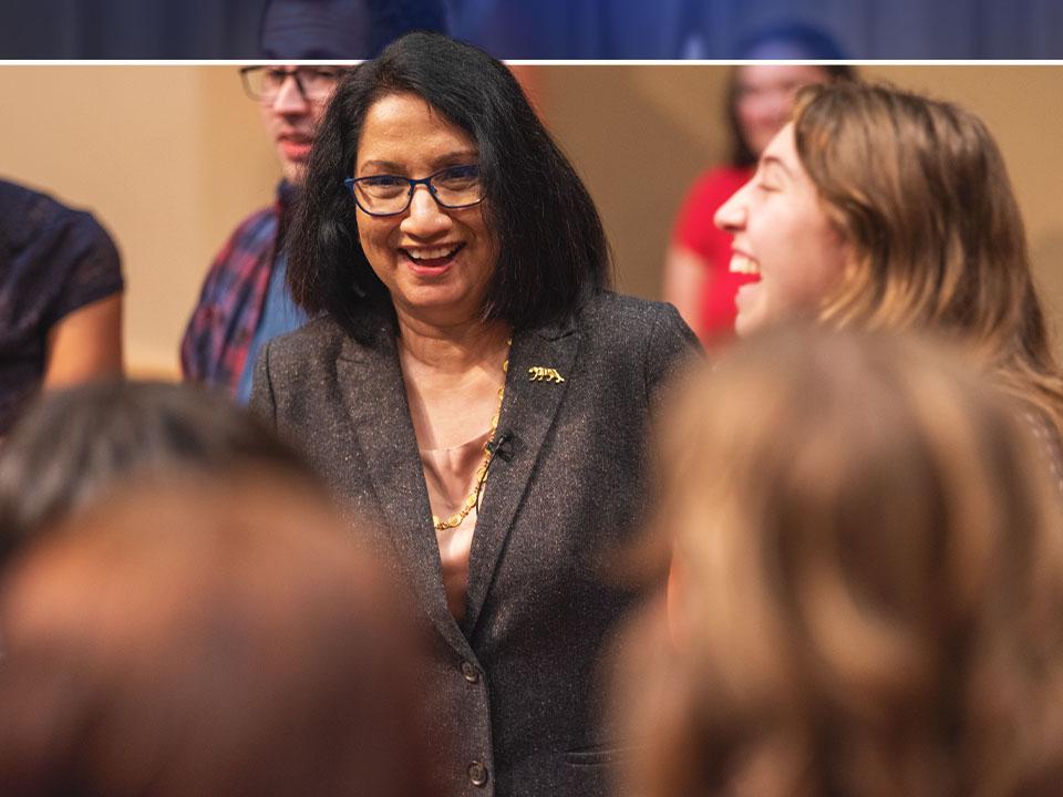 A candid photo of Neeli Bendapudi laughing with students.