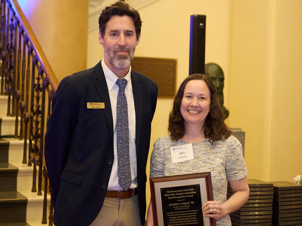 A photo of Ryan Jones, left, and Jennifer Crispell, who is holding a plaque.