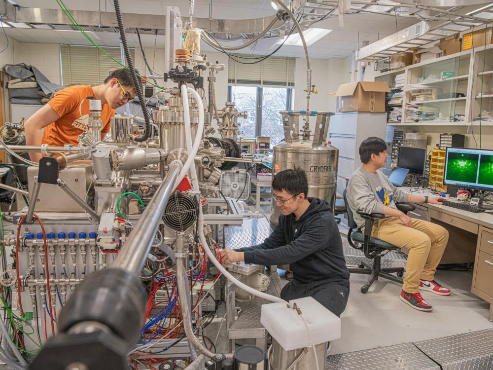 Han Tay, Pu Xiao, and Jie Yan operate a large piece of equipment