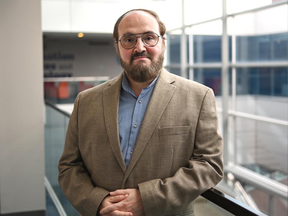 A distinguished professor at Penn State poses for a headshot.