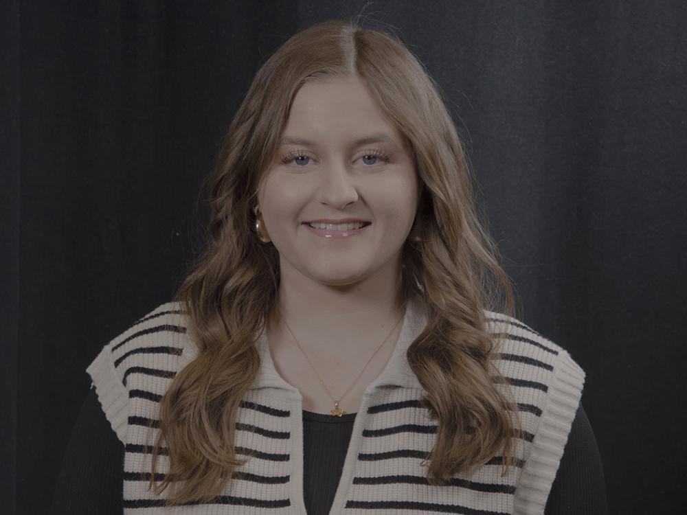 Smiling girl with brown shoulder length hair