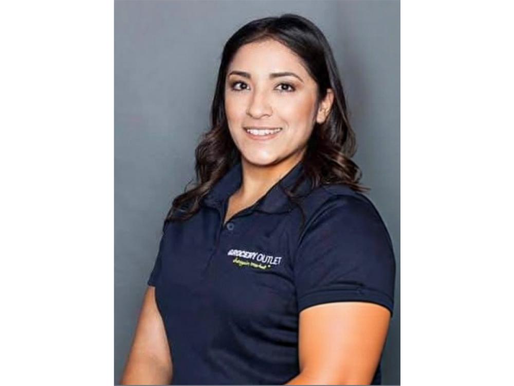 Amanda Paez wearing polo that says Grocery Outlet Bargain Market in top right corner