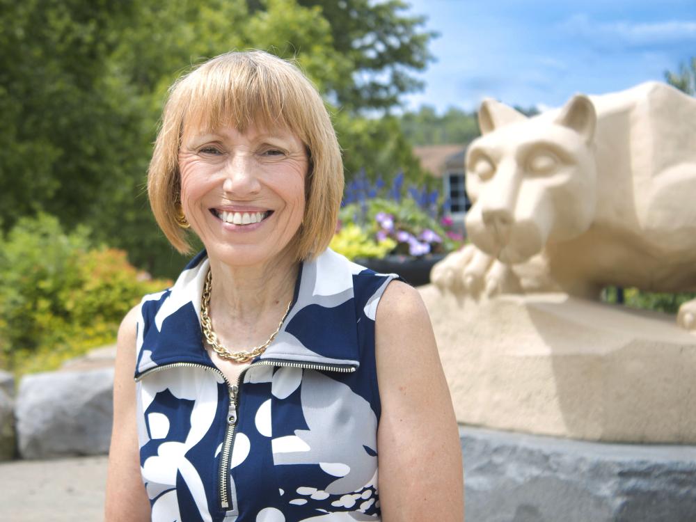 Dr. Darlne Dunay poses for a photo by the scranton campus' Nittany Lion Shrine