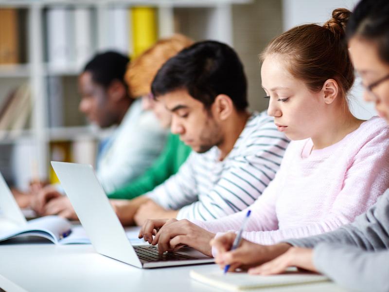 Students in a classroom on laptops.