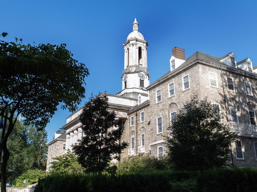 Old main with trees in shadows