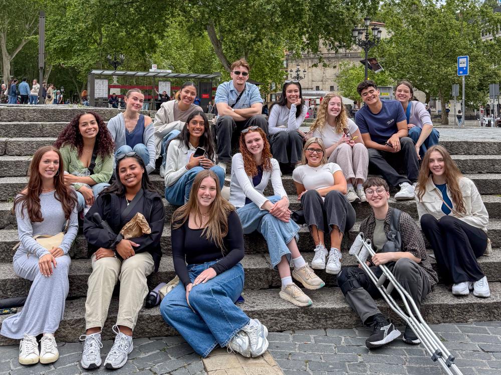 Penn State students sit on outdoor stairs in Bilboa, Spain.