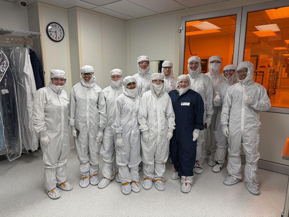 Scholars are in hazmat suits to tour the nanofabrication lab